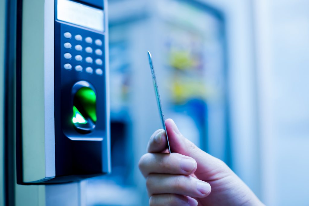 Door access control. Staff holding a key card to lock and unlock door at control room or data center. The concept of data security or data access control.