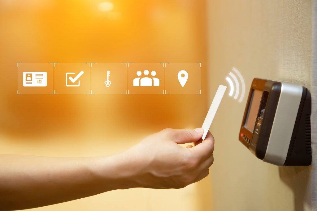 Proximity card reader door unlock, Hand security man using ID card on fingerprint scanning access control system for identity verification to open the door or for security safety or check attendance.